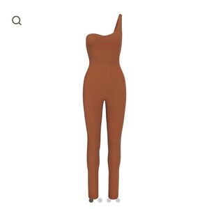 Skims one-shoulder bodysuit. Tags removed but never worn. Size XS